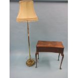 An early 20th century brass floor-lamp, with green shade, together with a burr walnut side table