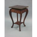 An Oriental occasional table, gilt-tooled leather chess-board top on four-legged carved wood