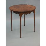 A Georgian provincial oak occasional table, circular top on slim tapering legs with pad feet, top