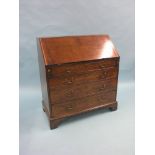 A George III oak bureau, fitted interior with seven drawers and central cupboard, four long