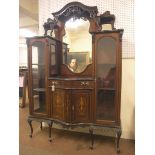 An Edwardian inlaid mahogany display cabinet, raised back with three bevelled and shaped mirror