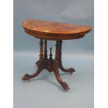 A Victorian inlaid burr walnut card table, half-round shape, on stem with four turned columns,