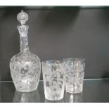 A glass decanter, bulbous-shape with stopper, and a pair of matching tumblers, all with crisp