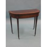 A Sheraton-period mahogany card table, half-round shape with broad satinwood cross banding, on slim,