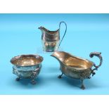A silver sugar bowl, on three lion-mask feet, London 1911, a George III engraved silver milk jug,