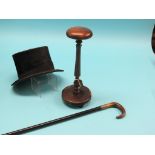 A top hat, by Tress & Co., London, on mahogany and elm hat stand, 15in. and a silver-mounted walking
