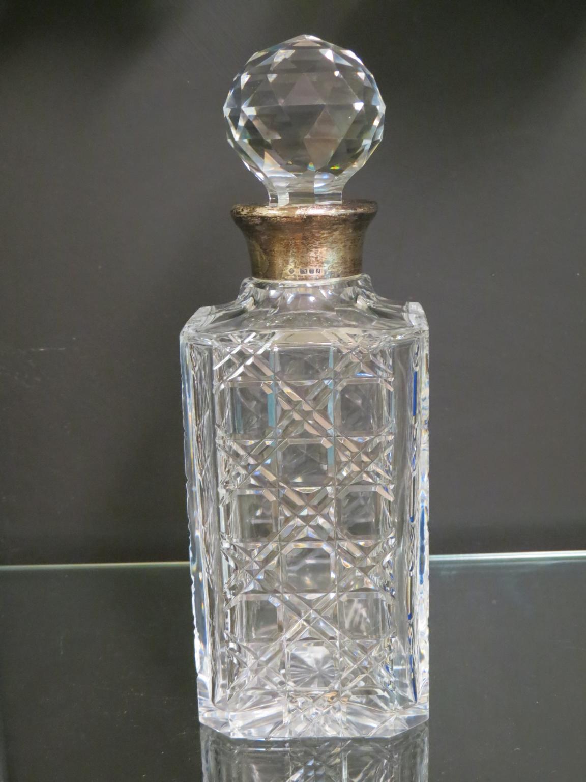 An Asprey silver-mounted glass spirit decanter, hobnail-cut body with stopper, London 1983, 10.5in.