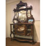 An Edwardian mahogany tall chiffonier, raised back incorporating bevelled mirror plates and shelves,