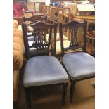 A set of four late Victorian dark walnut dining chairs, pierced vertical splats and seats