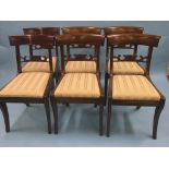 A set of four early 19th century mahogany dining chairs, with carved bar-backs, drop-in seats and