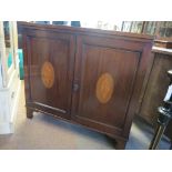 A late Victorian inlaid mahogany side cupboard, pair of panelled doors with box wood conch shells,