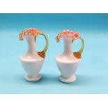 A pair of opaque, coloured glass ewers, frill rims with pink and amber colouring, 8in.