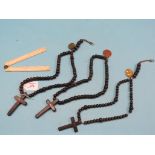 Three Christian rosaries, each with cross and brass pendants, and a Gilkerson folding bone rule