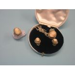 A suite of white metal cameo jewellery, pendant on chain, a ring and a pair of ear-clips, carved