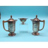 An Art Deco silver three-piece coffee set, two coffee pots, each with wood handle and finial, and