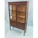 An early 20th century mahogany display cabinet, lined interior with two fitted shelves enclosed by a