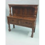 A 17th century-style solid, dark oak sideboard, raised canopy back with Jacobean carved panels, base