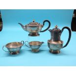 A silver four-piece teaset, teapot and hot water jug with wood handles, two-handled sugar bowl and