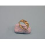 An 18ct. gold pearl half-hoop ring, set five graduated stones, size L