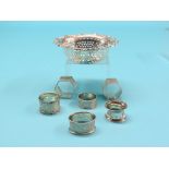 A pierced silver bowl, Chester 1908, and six silver serviette rings, approx. 8.5oz. total