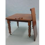 A Victorian walnut wind-action dining table, with extra leaf, on turned legs with casters, 3ft. 4in.