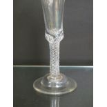 An 18th century wine glass, bell bowl above air-twist stem and domed foot, circa 1730, 8.5in.