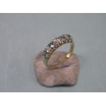 A 9ct. gold half-hoop ring, set three diamonds and four aquamarines, claw settings, size N