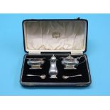 A cased silver condiment set retailed by Harrods,, salt, mustard, each with blue glass liner