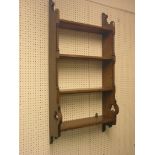 A Victorian Gothic Revival oak shelf unit, four fitted shelves, each end fronted with columns and