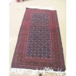 Two eastern wool rugs, the first red, black and cream, the second violet, ochre and cream, both 6ft.