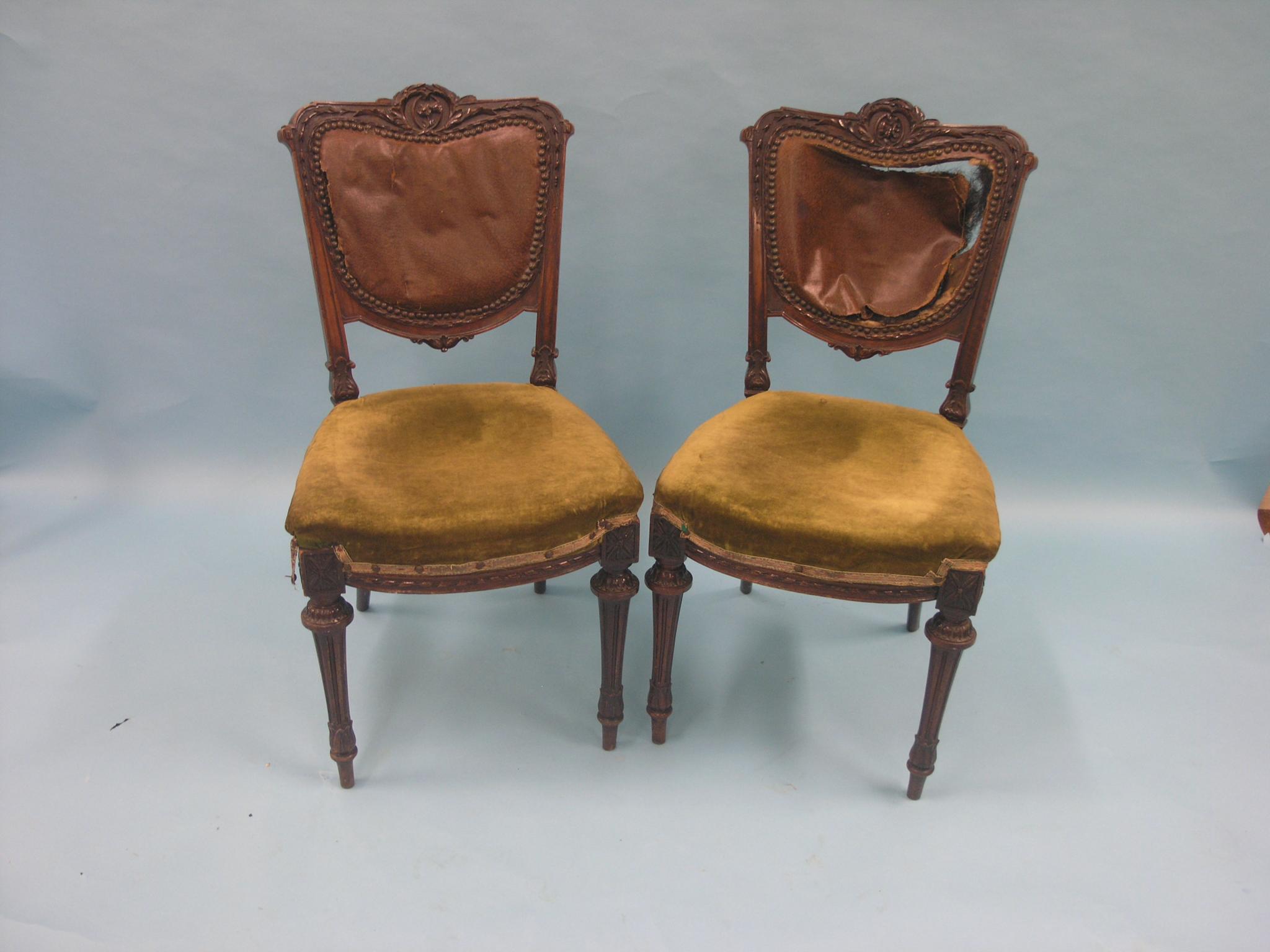 A pair of Victorian mahogany dining chairs, backs deeply-carved with foliage, on front tapering