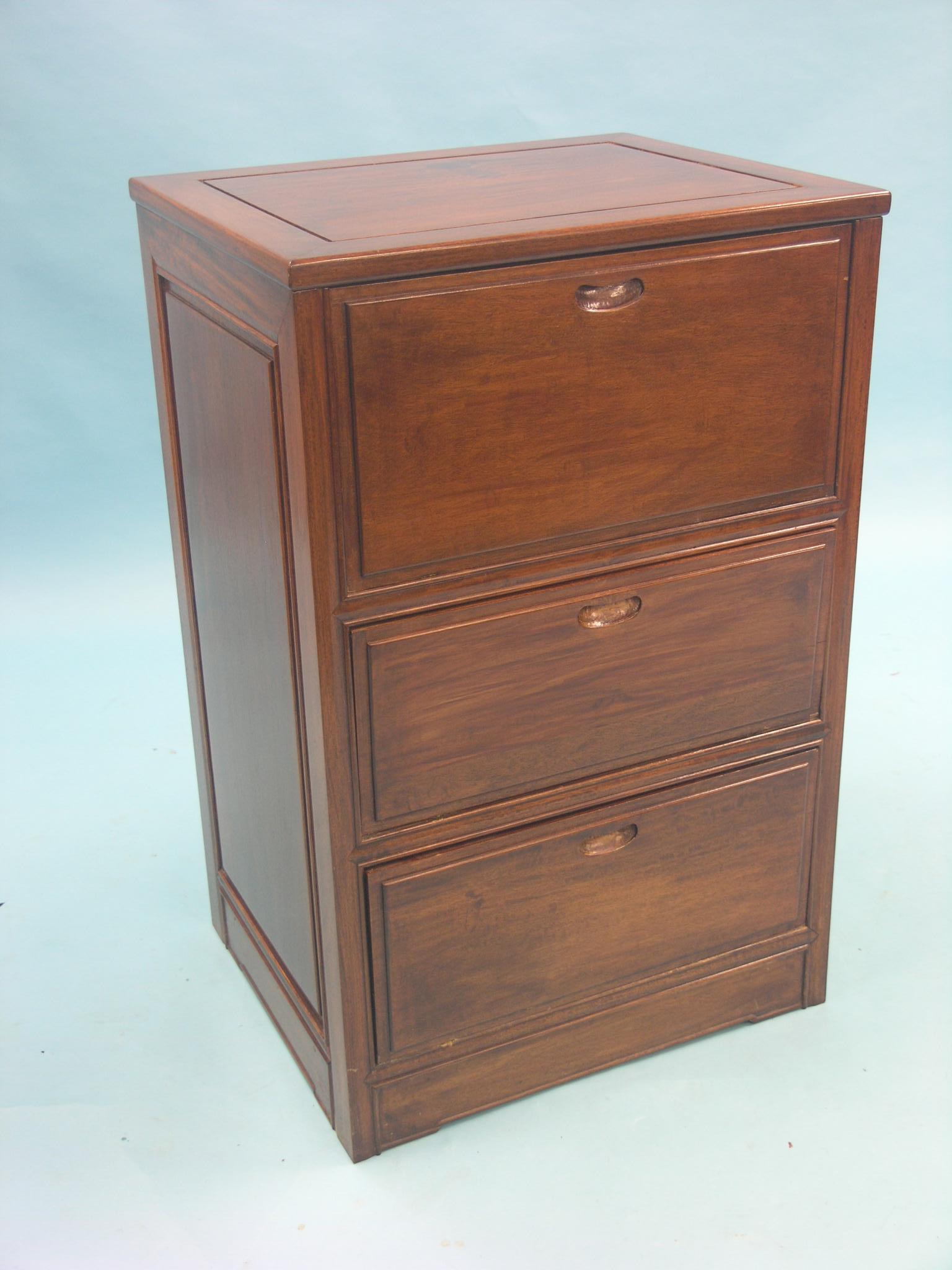 An Eastern hardwood chest, hinged top above three fall-front doors, 1ft. 10in. - lower drawer