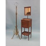 An early 20th century brass floor lamp, tripod base with scroll detail