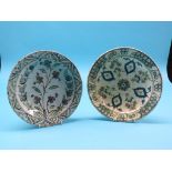 Two 18th century Hispano Moresque dishes, primitive floral paintwork against cream grounds, 10in.