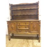 A Nero medium oak dresser, twin-shelf plate rack above cupboard base with three drawers, 4ft. 7in.