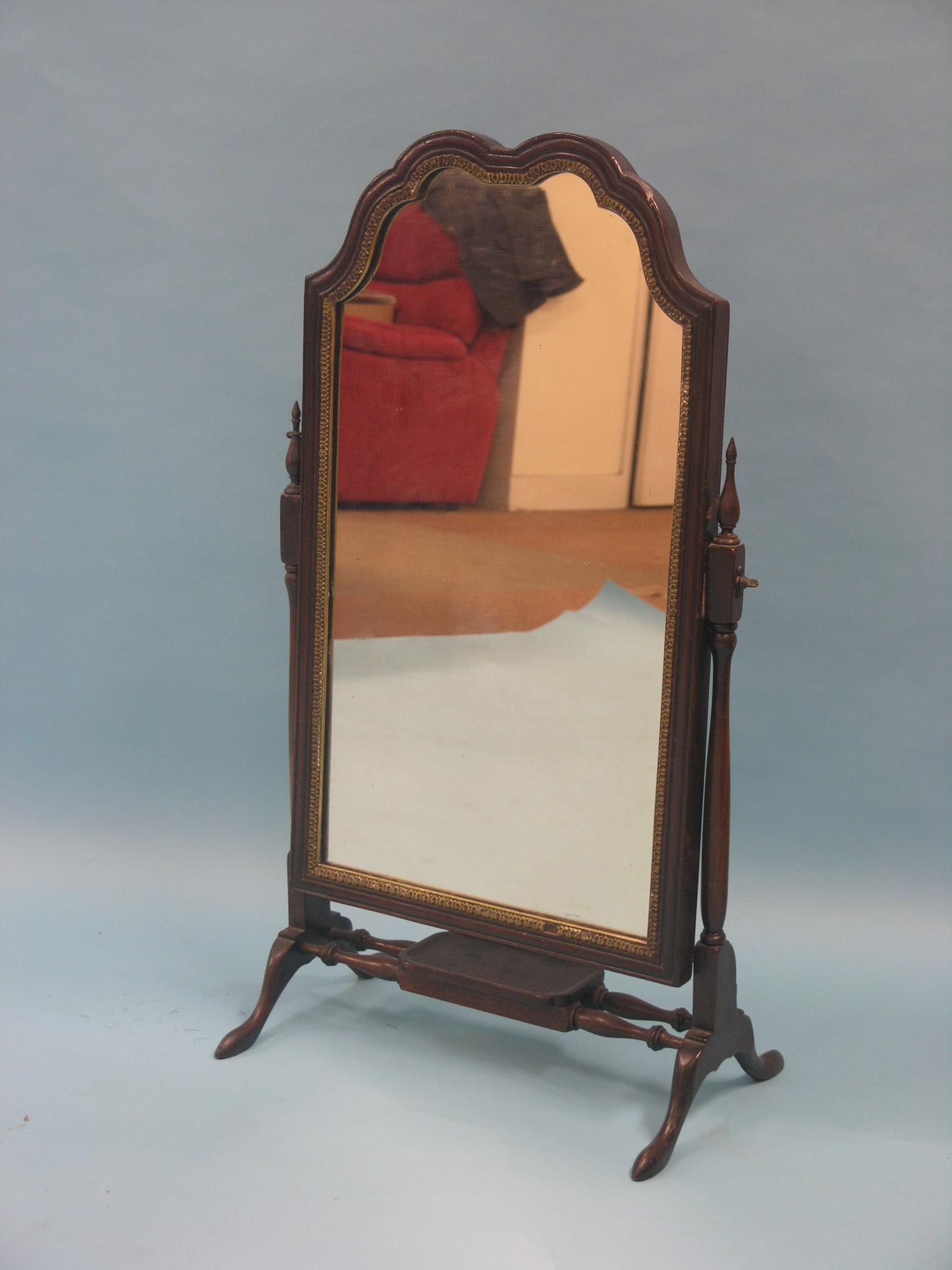 A Georgian-style mahogany dressing mirror, arched plate with gilt-gesso border, adjustable on turned