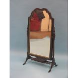 A Georgian-style mahogany dressing mirror, arched plate with gilt-gesso border, adjustable on turned