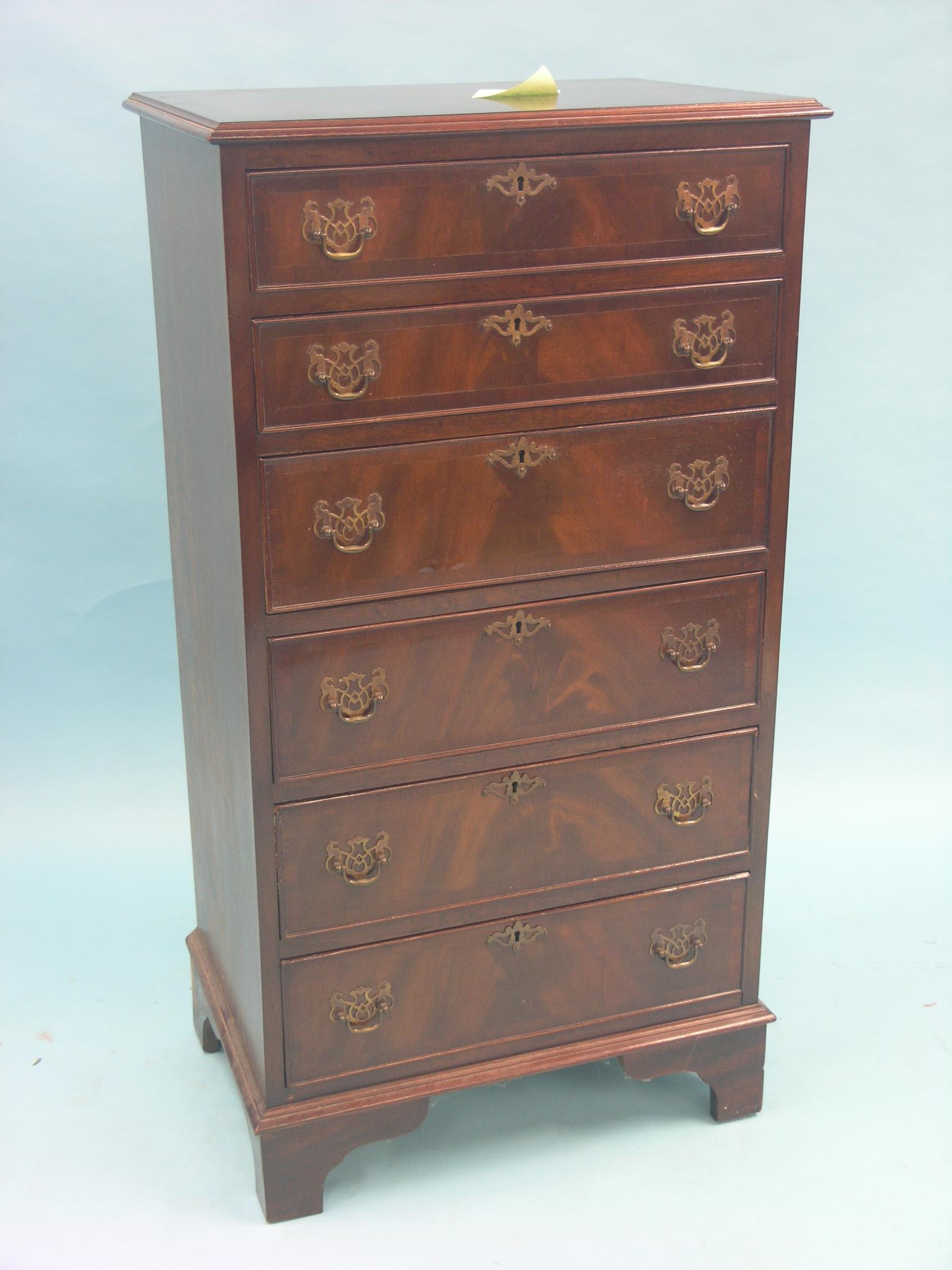 A reproduction mahogany chest, six cross-banded drawers with pierced brass handles, 1ft. 10in.