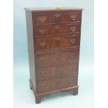 A reproduction mahogany chest, six cross-banded drawers with pierced brass handles, 1ft. 10in.