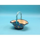 A Longwy ornamental earthenware basket, exterior with bright flowers against a vivid blue ground,