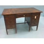 An early 20th century dark oak office desk, kneehole arrangement of six drawers, 4ft. - top marked