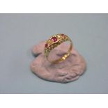 An 18ct. gold half-hoop ring, set three rubies and two diamonds