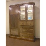 An Edwardian inlaid mahogany wardrobe, featuring panelled door, bevelled mirrored doors and an