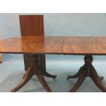 A George III mahogany dining table signed Woods, Dublin, twin-pedestals each with four moulded