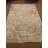 A Chinese wool rug, bright floral patterns against a beige field, 9ft. x 6ft.