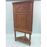 A large George II oak corner cupboard, door with fielded panels, two shaped shelves enclosed and