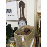 An early 20th century carved oak wheel barometer, 32in., a long-duration mantel clock, under glass