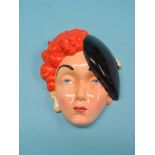 An unusual Beswick wall mask, Art Deco female, 9in. high, and a Clarice Cliff relief-moulded jug,