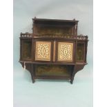 A Victorian ebonised shelf unit, in Anglo Indian style, pair of bone cupboard doors inlaid with