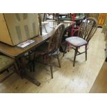 A dark oak dining table, refectory-type with shaped ends, top 6ft. 6in., and a set of six wheel-back